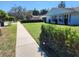Charming home exterior with a lush green lawn and well-manicured hedges at 2310 Medford Ln, Brandon, FL 33511