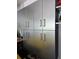 Silver metal garage cabinets with long, thin handles provide ample storage space at 2310 Medford Ln, Brandon, FL 33511