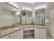 Bathroom with double sinks and a vanity with white cabinets and granite countertops at 2717 Via Cipriani # 631B, Clearwater, FL 33764