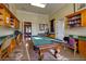 Charming billiard room with a classic pool table, built-in shelves, and cozy seating at 2717 Via Cipriani # 631B, Clearwater, FL 33764