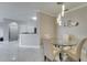 Open-concept dining area with glass table and view of the updated kitchen at 2717 Via Cipriani # 631B, Clearwater, FL 33764