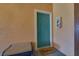 Condo entrance features a teal door, 