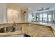Granite counters highlight this kitchen with stainless steel sink and open layout at 2717 Via Cipriani # 631B, Clearwater, FL 33764