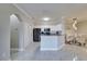 Modern kitchen with white cabinets, stainless steel appliances, and adjacent dining area at 2717 Via Cipriani # 631B, Clearwater, FL 33764