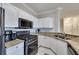 Kitchen featuring white cabinets, granite counters, and stainless steel appliances at 2717 Via Cipriani # 631B, Clearwater, FL 33764