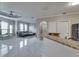 Bright living room features tray ceilings, tile floors, modern furnishings, and an abundance of natural light at 2717 Via Cipriani # 631B, Clearwater, FL 33764