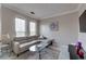 Modern living room with leather sofa, tile floors, and an abundance of natural light at 2717 Via Cipriani # 631B, Clearwater, FL 33764