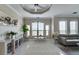 Bright living room features tray ceilings, tile floors, modern furnishings, and an abundance of natural light at 2717 Via Cipriani # 631B, Clearwater, FL 33764