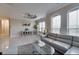 Bright living room features tile flooring, large windows, and comfortable seating at 2717 Via Cipriani # 631B, Clearwater, FL 33764