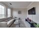 Modern living room with leather sofa, tile floors, and a flat-screen TV at 2717 Via Cipriani # 631B, Clearwater, FL 33764