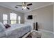 Bedroom with ceiling fan, tiled flooring, dresser, and view from large window at 2717 Via Cipriani # 631B, Clearwater, FL 33764