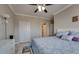 Main bedroom with tile flooring, ceiling fan, neutral walls, and double closet doors at 2717 Via Cipriani # 631B, Clearwater, FL 33764