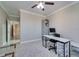 Office featuring a ceiling fan, a desk and chair, and view through a doorway at 2717 Via Cipriani # 631B, Clearwater, FL 33764