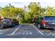 Reserved parking spot for space number 128 with two SUVs parked at 2717 Via Cipriani # 631B, Clearwater, FL 33764