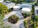 Aerial view of the home's driveway, landscaping, and modern exterior features at 307 Orangewood Ln, Largo, FL 33770