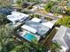 Aerial view of a modern home with a backyard pool, patio and fenced yard at 307 Orangewood Ln, Largo, FL 33770