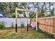 A backyard play area with swings and a slide at 307 Orangewood Ln, Largo, FL 33770