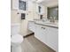 Well-lit bathroom features a framed mirror, stylish wood-look floor, and integrated vanity at 307 Orangewood Ln, Largo, FL 33770