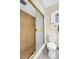 Well-maintained bathroom has a mosaic tiled shower with sliding door and modern toilet at 307 Orangewood Ln, Largo, FL 33770