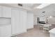 Bright dining room with white walls, and white louvered closet doors at 307 Orangewood Ln, Largo, FL 33770