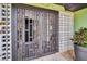 The front entry features a stylish gate, offering a glimpse of the interior, framed by modern decorative blocks at 307 Orangewood Ln, Largo, FL 33770