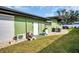 Exterior view of the home with grassy backyard at 307 Orangewood Ln, Largo, FL 33770