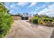 Exterior view of home with a long driveway and lush landscaping at 307 Orangewood Ln, Largo, FL 33770