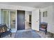Front entrance features a modern door, sidelight windows and chairs at 307 Orangewood Ln, Largo, FL 33770