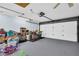 Cluttered garage with lots of storage space features an automatic door and concrete floor at 307 Orangewood Ln, Largo, FL 33770