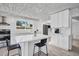 Modern kitchen with white cabinetry, tile backsplash and stainless steel appliances at 307 Orangewood Ln, Largo, FL 33770