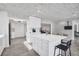 Bright kitchen featuring white cabinetry, quartz countertops, and stainless steel refrigerator at 307 Orangewood Ln, Largo, FL 33770