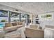 Open floor plan showcases living room and modern kitchen with pool views at 307 Orangewood Ln, Largo, FL 33770