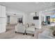 Living room featuring grey tile floors, white textured walls, and modern furniture at 307 Orangewood Ln, Largo, FL 33770