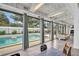 Bright living room with floor-to-ceiling windows offering views of the backyard pool at 307 Orangewood Ln, Largo, FL 33770