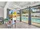 Bright sunroom with access to the outdoor pool and backyard entertainment space at 307 Orangewood Ln, Largo, FL 33770