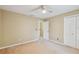 Bedroom with ceiling fan, beige carpet, and closet at 3212 W Villa Rosa St, Tampa, FL 33611