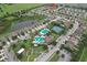 Aerial shot of community with pool, tennis courts, and surrounding homes and green spaces at 32829 Woodthrush Way, Wesley Chapel, FL 33545