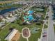 Stunning aerial view of community amenities including pool, playground, tennis and basketball courts, and lush green spaces at 32829 Woodthrush Way, Wesley Chapel, FL 33545