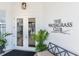 The Watergrass Club entrance featuring double doors, signage, and decorative plants at 32829 Woodthrush Way, Wesley Chapel, FL 33545