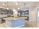 Stylish kitchen featuring stainless steel appliances, granite countertops, a center island with seating, and ample cabinet space at 32829 Woodthrush Way, Wesley Chapel, FL 33545