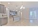 Modern kitchen with stainless steel appliances, granite countertops, and a central island, perfect for culinary enthusiasts at 32829 Woodthrush Way, Wesley Chapel, FL 33545