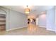Expansive living space featuring tile flooring, neutral walls, and an open layout, seamlessly connecting to the kitchen area at 32829 Woodthrush Way, Wesley Chapel, FL 33545