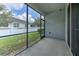 A screened-in patio offers a view of the backyard and a privacy fence at 32829 Woodthrush Way, Wesley Chapel, FL 33545