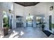 Pool entrance featuring gated access points, poolside seating, and tropical plants at 32829 Woodthrush Way, Wesley Chapel, FL 33545