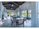Covered patio seating with ceiling fans, overlooks community pool and landscaping at 32829 Woodthrush Way, Wesley Chapel, FL 33545
