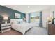 This bedroom features an accent wall, plush carpet, bright windows, and stylish furnishings at 33096 Osprey Peak Way, San Antonio, FL 33576