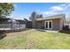 View of a fenced-in backyard with grass, patio, screened-in pool, and back of house at 4034 Paddlewheel Dr, Brandon, FL 33511