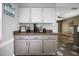 Charming coffee bar featuring white cabinets, stylish countertops, and a decorative backsplash and view to dining area at 4034 Paddlewheel Dr, Brandon, FL 33511