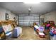 View of a cluttered garage with items, including a bicycle, boxes, suitcase, and shelves at 4034 Paddlewheel Dr, Brandon, FL 33511