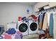 Laundry room with a washer, dryer, sink, clothes rack, and storage shelves at 4034 Paddlewheel Dr, Brandon, FL 33511